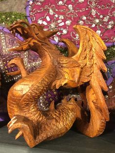 two wooden dragon figurines sitting next to each other