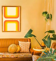 a living room filled with lots of furniture next to a painting and potted plants