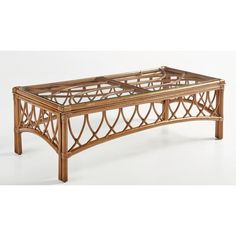 a coffee table made out of bamboo and glass with an intricate design on the top