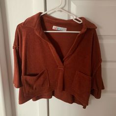 Perfect Condition. Never Worn! Color Is Kind Of A Rusty Red. Oversized Fit Cozy Tops With Pockets, Red Long Sleeve Cropped Sweater, Collared Fall Loungewear Tops, Casual Red Cropped Long Sleeve Sweater, Collared Loungewear Tops For Fall, Oversized Red Top For Loungewear, Red Oversized Tops For Loungewear, Trendy V-neck Top With Pockets, Oversized Short Sleeve Fall Sweater