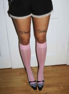 a woman wearing pink stockings and black shorts