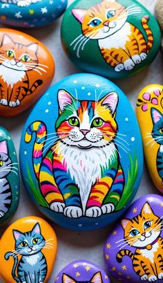 colorful painted rocks with cats on them