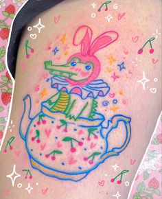 a woman's thigh with an image of a rabbit in a teapot on it