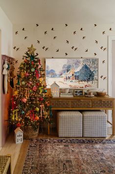 a living room with a christmas tree in the corner and birds on the wall above it