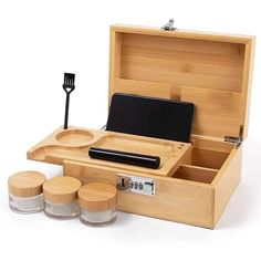 an open wooden box with three small containers