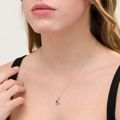 Shine vividly with this resplendent fashion teardrop pendant. Crafted in cool 10K white gold, this elegant style features a 7.0 x 5.0mm pear-shaped lab-created violet-purple alexandrite embraced by polished and diamond-accented cascading-style ribbons. Buffed to a brilliant luster, this pendant suspends along an 18.0-inch rope chain that secures with a spring-ring clasp. Elegant Pear-shaped Sterling Silver Drop, Elegant Jewelry With Teardrop Gemstone Pendant, Elegant Jewelry With Teardrop Pendant Gemstone Accents, Elegant Teardrop Birthstone Drop Necklace, Elegant Teardrop Pendant Jewelry With Gemstone Accents, Elegant White Gold Teardrop Pendant Necklace, Elegant Briolette Drop Necklace In White Gold, Elegant White Gold Briolette Drop Necklace, Fine Jewelry Cubic Zirconia Teardrop Pendant Necklace