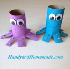 two toilet paper rolls with googly eyes and an octopus made out of them sitting on a table