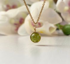 This beautifully simple necklace is lovingly handmade with a tiny Peridot gemstone and a choice of 14k Gold Filled, 14k Rose Gold Filled or Sterling Silver Chain. M A T E R I A L S: * Peridot * 14k Gold Filled, 14k Rose Gold Filled or Sterling Silver Chain S I Z E: *  Gemstones - Approximately 6mm *  Chain Thickness - Approximately 1.1mm  All of our jewellery is carefully handmade using good quality materials and handpicked gemstones, with the aim to produce quality pieces that you can love & wear for years to come.  P E R I D O T: * August Birthstone * Talisman for Gemini, Leo, Virgo, Scorpio, Sagittarius  * Heart Chakra, Solar Plexus Chakra Peridot is a powerful cleanser.  It alleviates jealousy, resentment, spite, bitterness, irritation, hatred and greed.  Reduces stress, anger and guil Virgo Scorpio, August Birthstone Necklace, Green Gemstone Necklace, Gemini Leo, White Jewelry Box, Peridot Pendant, Peridot Necklace, Leo Virgo, Solid Gold Chains