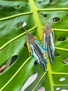 Beautiful and colorful beaded fringe earrings with matte gold, shades of blue, yellow and cream Toho seed beads. This dangly natural colors pair will complete your outfit with a bohemian touch. wear for any occasion and makes a perfect gift. Approximate measuring: Length- 4.1" Width-  1" Ear wire is made of iron, nickel free. each pair is handmade with love, made to order. Fringe Beaded Earrings, Measuring Length, Gold Shades, Beaded Fringe, Diamond Shaped, Earrings Boho, Seed Bead Jewelry, Fringe Earrings, Natural Colors