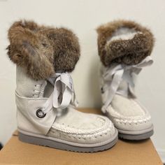 These Boots Are Absolutely Gorgeous With Cream Suede And A Gray Ribbon Tie. The Fur Is Genuine Brown Rabbit And The Inside Is Lined With Shearling Fur. If You’ve Ever Tried Mou Boots, They Are So Comfortable And Incredible Quality. These Are Brand New, Never Been Worn And Come With The Box. Brown Boots White Fur, White Sheepskin Boots For Winter, White Sheepskin Winter Boots, Winter White Sheepskin Boots, Boots With The Fur, White High-top Suede Boots, White Faux Fur Boots With Round Toe, Sheepskin Round Toe Boots, Grey Ribbon