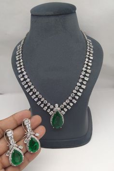 Premium Quality Indian Ad Cz Silver Plated Emerald Necklace Set Very Pretty and Gorgeous white gold plated Intricately Made Emerald Cz necklace with matching earrings. Silver Finish High Quality Corian Stones Real Doublet Stone Highest quality and craftsmanship The Necklace Has Adjustable Chain The Earrings Have Pushbacks . * This Set Is made up with High Quality american diamond stones * Silver Plating Is used * High Quality Beads Are used * Set includes Necklace,Earrings  About us: Kundanjewel Corian Stone, Emerald Set, Beautiful Tiaras, Indian Necklace, Semi Precious Jewelry, Cz Necklace, Emerald Necklace, Emerald Jewelry, American Diamond