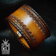 "This brown leather cuff bracelet is custom dyed in a light brown fade to dark chocolate edges . It's stamped inside the perimeter and the edges are whipstitched in chocolate leather lace. Two hand distressed snaps provide the closure. A great width for any wrist! I'll need your wrist size for this cuff! Please use the instructions in the pics above! - 1.5\" wide - Hand-tooled and stamped - Laced edge Thanks for checking out my work! I use a fine hand in my work bridging the gap between Art &amp Brown Engraved Leather Bracelet, Brown Engraved Cuff Bracelet Gift, Engraved Brown Leather Bracelet, Handmade Brown Cuff Bracelet, Vintage Brown Engraved Cuff Bracelet, Engraved Brown Cuff Bracelet Gift, Hand Tooled Brown Cuff Bracelet, Brown Engraved Leather Cuff Bracelet, Brown Leather Engraved Cuff Bracelet