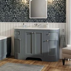 a bathroom with a sink, mirror and bathtub in the middle of the room