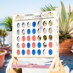 an outdoor game is set up in front of some potted plants