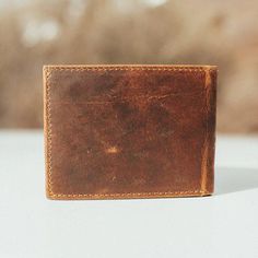 The Classic Mens Bifold Leather Wallet Made from quality, genuine leather, this men's bifold leather wallet is made to go the distance. With 9 separate cardholder slots, you can fit all your debit, credit and membership cards in this men's brown leather wallet. With an additional clear pocket for your ID, this bifold wallet is also built to make it convenient to flash your driver's license. Need even more space? The two inside left and right pockets can take even more of your cards or any loose change. Keep your bills stored in either one of the two full-width pockets on the top of this bifold leather wallet. Say hello to your new premium everyday pocket buddy, The Bifold. Features A genuine top grain leather wallet Bifold wallet design Nine card slots in the inside of the wallet Two addit Mens Leather Wallet Bifold, Wallet Design, Minimalist Leather Wallet, Fun Wallets, Real Leather Bags, Id Design, Loose Change, Brown Leather Wallet, Front Pocket Wallet