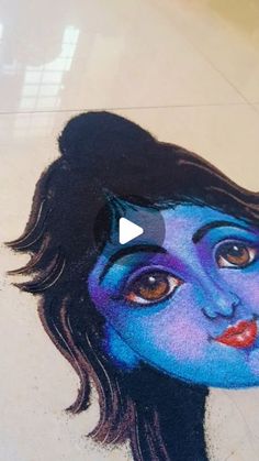 an image of a woman's face painted on the floor with blue and purple colors