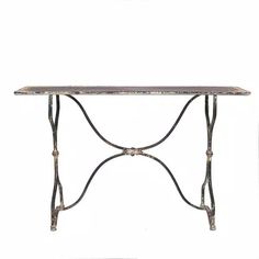 an iron table with marble top and metal legs