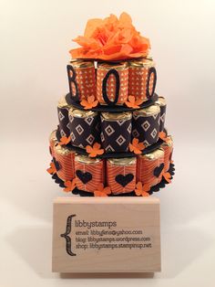 there is a cake made out of beer cans and orange flowers on top of it