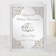 an elegant 60th wedding anniversary card with silver glitter and gold foil on the front,