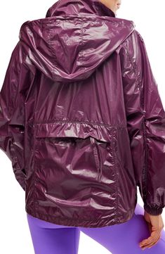 Rainy days won't slow you down in this cool rain jacket with a large hood for added protection and a lightweight, packable design for stowing it in your bag. 28" length Half-zip closure Stand collar; drawcord-toggle hood Elastic cuffs Side-seam patch pockets; back zip pocket Drawcord hem Packs into back pocket Water-resistant Unlined 100% nylon with polyurethane coating Machine wash, dry flat By Free People; imported Packable Hooded Outerwear For Travel, Rainy Season Nylon Windbreaker With Adjustable Hood, Nylon Windbreaker With Adjustable Hood For Rainy Season, Travel Nylon Raincoat With Adjustable Hood, Nylon Windbreaker For Rainy Season, Functional Nylon Raincoat For Travel, Sporty Nylon Raincoat For Travel, Windproof Nylon Travel Raincoat, Fall Purple Nylon Windbreaker