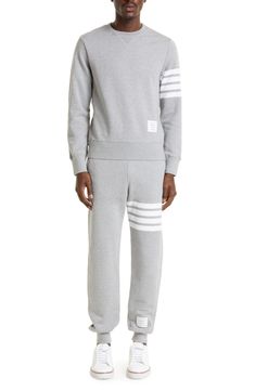 A quartet of thick stripes bands one arm of a well-appointed cotton sweatshirt replete with dapper details like a signature logo patch and a buttoned split hem. 25" length (size 2) Side button closure Crewneck Long sleeves with ribbed cuffs 100% cotton Dry clean Made in Japan Cotton Sweatshirt With Contrast Stripes In Relaxed Fit, Relaxed Fit Cotton Sweatshirt With Contrast Stripes, Cotton Striped Sweatshirt With Striped Cuffs, Cotton Crew Neck Sweatshirt With Striped Cuffs, Winter Cotton Sweatshirt With Contrast Stripes, Casual Long Sleeve Sweatshirt With Signature Stripes, Cotton Sweatshirt With Striped Cuffs For Fall, Fall Cotton Sweatshirt With Striped Cuffs, Cotton Crew Sweatshirt With Three Stripes Branding