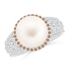 The coffee diamond halo enhances the allure of the Freshwater cultured pearl. Prong and bezel-set white diamonds embellish the split shank and lend their brilliance to the design. The intricate milgrain work and the filigree on the gallery elevate the exquisiteness of this ring in 14k white gold. Cultured Pearl Ring, Diamond Halo Ring, Split Shank, Halo Diamond Ring, Halo Ring, Halo Rings, Diamond Halo, White Diamonds, The Coffee