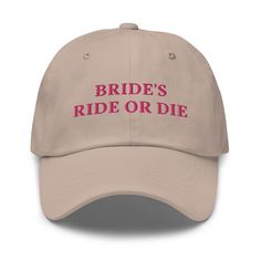 the bride's ride or die hat is tan with pink lettering on it and red letters