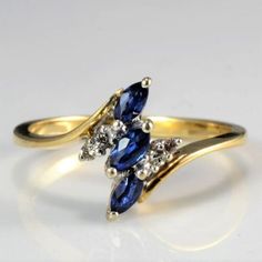 two gold rings with blue and white stones