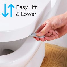 a person is using an easy lift and lower level toilet seat