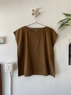 100% cotton tunic by Uzi NYC. Free size. Casual Brown Cotton Blouse, Brown Relaxed Fit Crew Neck Blouse, Cotton Tops Crew Neck For Daywear, Cotton Crew Neck Tops For Daywear, Cotton Tunic With Relaxed Fit For Daywear, Relaxed Fit Cotton Tunic For Daywear, Brown Relaxed Fit Cotton Top, Casual Tunic Top For Loungewear, Brown Short Sleeve Cotton Blouse