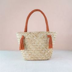 DESCRIPTION Fun meets functional in this modern market tote. Featuring a rich herringbone texture with natural seagrass fiber and braided cord handles. Handwoven by women weavers using traditional techniques. Each item empowers artisans in the Philippines. DETAILS • DIMENSIONS: Approx. L16" x W7.5" x H10.5" with 9" handle drop • MATERIAL: Seagrass, macrame cord • COLOR: Rust, natural CARE Spot clean only. Keep dry and store away from direct sunlight. Unique Handles, Modern Market, Herringbone Texture, Clear Tote Bags, Work Tote Bag, Straw Tote Bag, Hand Woven Baskets, Nylon Tote Bags, Natural Care