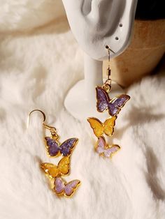 Elevate your style with a touch of royalty wearing these enchanting handmade resin butterfly dangle earrings. The rich combination of purple and gleaming gold creates a regal and captivating accessory that adds a dash of sophistication to any ensemble. -crafted with UV Resin, Alloy Hypoallergenic All earrings are handmade by me and there may be minor variations. Colors may vary slightly from photos. Contact me if you have any questions.  Care instructions: Clean with a soft jewelry polishing clo Gold Butterfly Earrings, Soft Jewelry, Resin Butterfly, Butterfly Earring, Butterfly Earrings Gold, Mother Day Gift, Butterfly Jewelry, Gift For Mother, Gold Butterfly