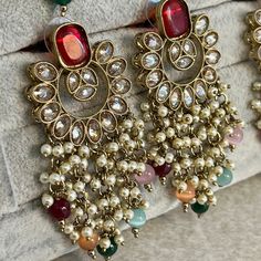 The most stunning multi colour crystal drop earrings, lightweight and adorned with zircon crystals and beauitful bead work. Measurements 2.5 inch Width x 1.5 inch length Perfect for any glam occasion.  Ready to ship! Luxury Kundan Chandelier Earrings For Festive Season, Luxury Festive Meenakari Jhumkas, Luxury Red Chandbalis For Festive Season, Luxury Multicolor Festive Jhumkas, Luxury Bollywood Multicolor Jhumkas, Luxury Traditional Chandbalis For Navratri, Luxury Festive Chandbalis For Party, Luxury Zari Work Chandbalis For Diwali, Luxury Festive Chandbalis