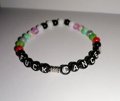 This a personized bracelet. You can choose between black round flat letter needs with with white letter A-Z and black rounded square breeds with colored letter A-Z (orange, yellow, green, blue, purple, hot pink, light pink). And you can also get your Favorit colors on the beds for the rest of the bracelet. You can choose between elastic bracelet or a non elastic bracelet that you can adjust the length yourself. Trendy Multicolor Jewelry With Letter Print, Customized Black Round Jewelry, Trendy Jewelry With Letter Print On Round Beads, Black Jewelry With Letter Beads For Friendship, Friendship Black Jewelry With Letter Beads, Casual Black Bracelets For Streetwear, Black Friendship Bracelets With Letter Beads, Trendy Beaded Bracelets With Letter Print For Gift, Trendy Beaded Bracelets With Letter Print As Gift