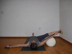 a man is doing exercises on a mat with a large ball in the middle of his body