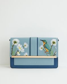 Key Features:



Nature-Inspired Design: Our Kingfisher Green rustic bag from the hero narrative Morning Song brings the essence of the English countryside to your outfit. The pastel blue hue evokes images of rambling meadows and dreamy riversides where our beautiful friend, the Kingfisher, thrives.


Functional Crossbody Strap: Designed with a crossbody strap, offering you the freedom to explore your surroundings on carefree jaunts.


Durable Construction: Crafted from 100% Polyurethane outer a Blue Canvas Shoulder Bag For Spring, Blue Pouch Shoulder Bag For Spring, Blue Satchel Shoulder Bag For Spring, Blue Bags With Floral Embroidery For Daily Use, Blue Embroidered Summer Shoulder Bag, Summer Blue Embroidered Shoulder Bag, Blue Embroidered Satchel Bag, Blue Embroidered Shoulder Bag For Summer, Daily Use Blue Bags With Floral Embroidery