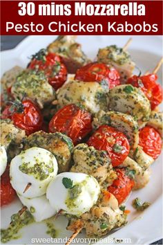 chicken kabobs with tomatoes and pesto on skewers are ready to be eaten