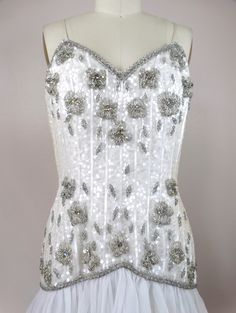 "This is a gorgeous little vintage couture dress! It's completely hand sewn, embellished with white sequins, glass beading and accented with iridescent rhinestone crystals. It's in excellent condition! Bust - 36\" Waist - 29\" Hips - 38\" Length - 33\" Tag Size - 8 All of my items come from a pet-free and smoke-free home. If you would like more info or have any questions, please don't hesitate to ask!" Sequined Mini Dress, Mini Dress Vintage, Iridescent Dress, Ruffled Mini Dress, Checkered Jacket, Couture Dress, Rhinestone Dress, Vintage Couture, Bustier Dress