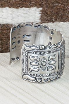 This sterling silver bracelet was made by Navajo silversmith Eugene Charley. The inside is signed and stamped sterling.Size: 5 3/4" (will fit up to a 7" wrist)Gap: 1 1/4"Width: 1 1/2"Free shipping on all orders! We ship with USPS and always include tracking. All orders ship within a day of payment.Returns are accepted up to 30 days after you receive your order. Just send us a message. Our shop offers cash back or store credit. The item must be returned in new condition. Western Sterling Silver Cuff Bracelet Gift, Western Style Silver Cuff Bracelet Gift, Western Style Silver Cuff Bracelet As A Gift, Vintage Stamped Sterling Silver Cuff Bracelet, Vintage Sterling Silver Stamped Cuff Bracelet, Handmade Western Sterling Silver Cuff Bracelet, Handmade Western Silver Cuff Bracelet, Adjustable Stamped Sterling Silver Bracelet, Western Style Stamped Cuff Bracelet