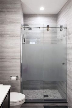 a bathroom with a shower, toilet and sink