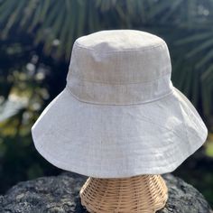 A beige linen sun hat for beach days and summer fun. This sun hat for women has a nice wide brim to protect your whole face and even your neck and chest. This hat folds easily to bring along in your bag. This hat is made from a medium weight homespun linen and cotton blend fabric in a neutral beige color. Inside liner is white cotton. I used a stiff interfacing for brim to keep it's shape. Brim measures 4.5" Crown depth is 3.5". Contact me for custom fit option. SIZES AVAILABLE S - measures 22.5 Beige Casual Bucket Hat For Travel, Casual Beige Bucket Hat For Travel, Linen Short Brim Hat, Linen Hat With Short Brim, Spring Bucket Hat With Uv Protection In Natural Color, Natural Bucket Hat For Spring Outdoor, Lightweight Natural Color Casual Bucket Hat, Spring Natural Color Bucket Hat For Outdoor, Lightweight Summer Bucket Hat For Travel