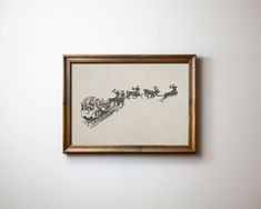 a framed drawing of santa's sleigh and reindeers