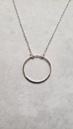 "Sometimes you need just a little something to give that extra spark to your outfit. This is it. This simple yet elegant necklace will soon be a favorite. It features your choice of a repurposed silver circle charm that is just shy of 1\" in diameter or a repurposed bronze silver circle charm that is 3/4\" in diameter. Both dangle from a 16\" chain with a 2\" extender. It's a minimalist's dream as it will wear well with all outfits. Your choice of color - silver-tone or antique bronze. Welcome t Simple Round Everyday Necklace, Simple Everyday Round Necklace, Minimalist Round Charm Necklace For Bridesmaid, Minimalist Round Sterling Silver Necklace, Handmade Everyday Circle Necklace, Simple Everyday Circle Necklaces, Simple Everyday Circular Necklace, Minimalist Open Circle Charm Necklace With Adjustable Chain, Dainty Open Circle Charm Necklaces For Everyday