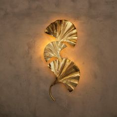 a wall light that is shaped like a leaf