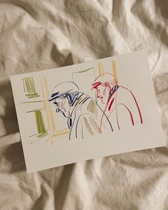 a drawing of two men sitting next to each other on a sheet of white paper