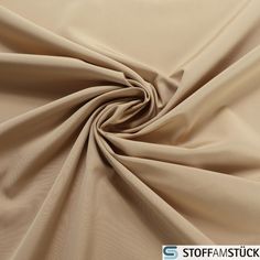 a close up view of a tan colored fabric that is very soft and drapy