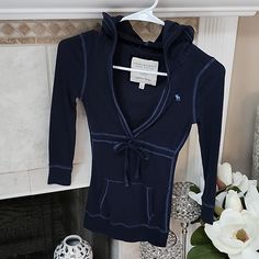 Excellent Condition!! Rare Find!! Size Small Color: Navy Front Tie Can Be Adjusted To Liking *Final Price! No Further Discounts!* All Items From Smoke-Free & Pet-Free Home Will Not Ship Internationally. All Sales Are Final. No Returns. Please Ask Any Questions You Have Before Purchasing. Thank You! Blue Fitted Hoodie For Fall, Fitted Blue Hoodie For Fall, Fitted Long Sleeve Blue Hoodie, Cozy Fitted Hooded Top, Fitted Long Sleeve Casual Hoodie, Blue Fitted Casual Hoodie, Casual Fitted Blue Hoodie, Fitted Tops With Drawstring Hood For Loungewear, Fitted Lounge Tops With Drawstring Hood