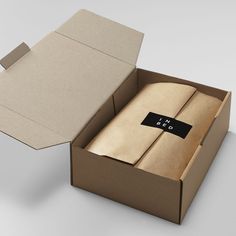 an open cardboard box with a tie in it