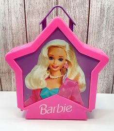 a barbie doll in a pink frame with the name barbie on it's side