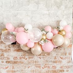 balloons and flowers are arranged on the mantle